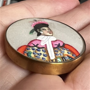 Painting on silk fabric button of an Asian man.