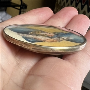 HUGE oval painting of a woman in huge hat set in silver button.