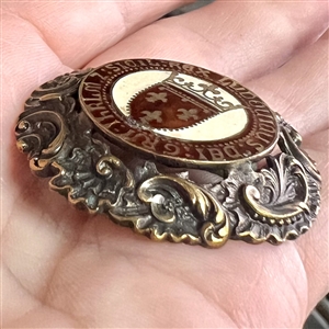 Large brass button with enamel center of verbal around French shield and crown.