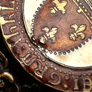 Large brass button with enamel center of verbal around French shield and crown.