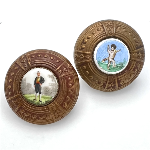 Two painted porcelain buttons set in brass.