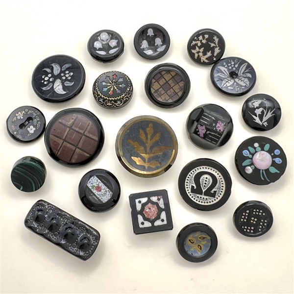 Twenty black glass buttons.