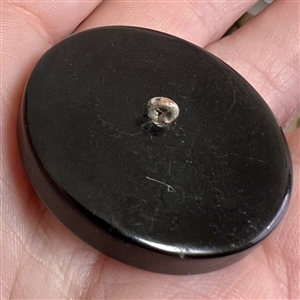 Bakelite button of a horse with metal eye.