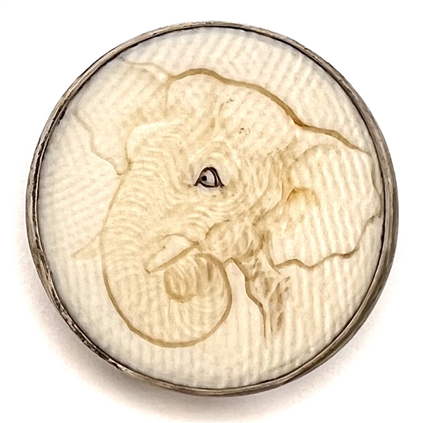 Carved natural material of an elephant head set in silver.