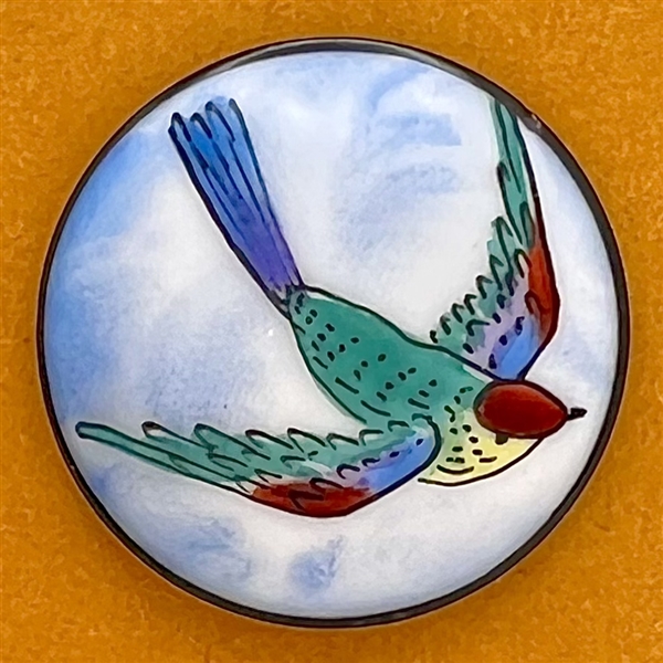 Painted white glass button of a flying bird.