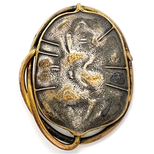 Arts and Crafts metal button of a stylized leaf.