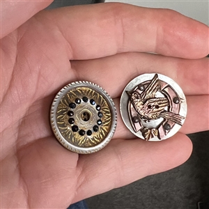 Two cool carved pearl buttons.