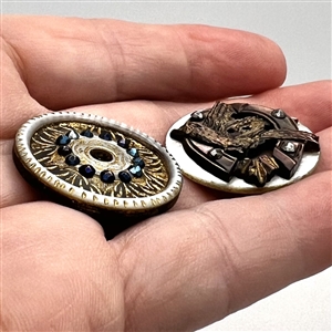 Two cool carved pearl buttons.