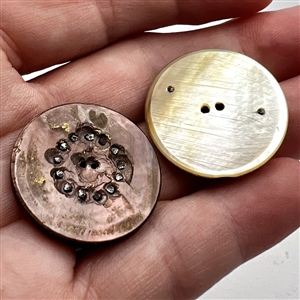Two cool carved pearl buttons.