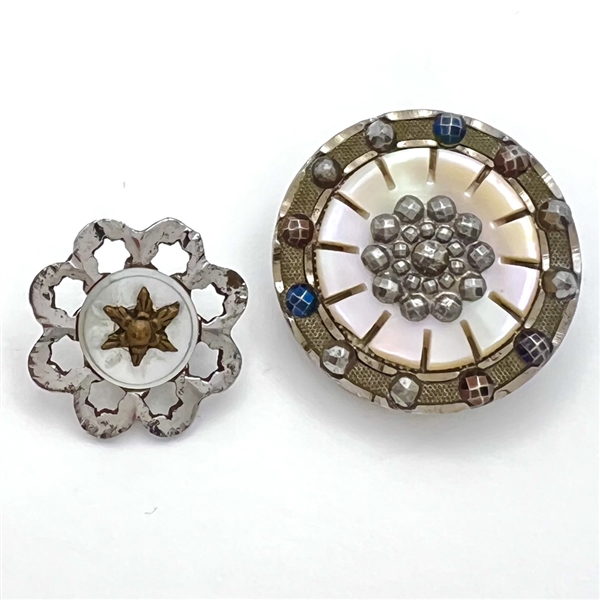 Two steel and pearl buttons.