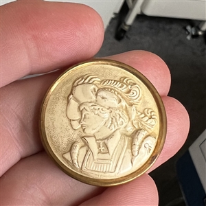 Ivoroid button of young man in 16th century costume.