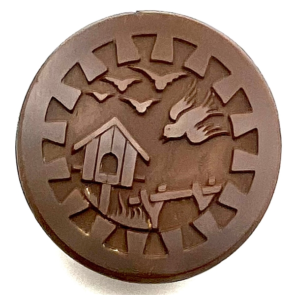 Brown glass button of birds and bird house.