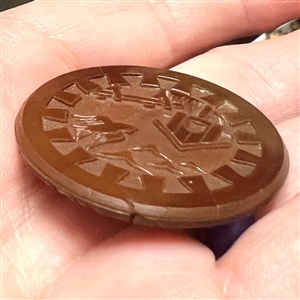 Brown glass button of birds and bird house.