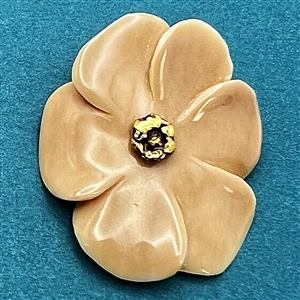 Carved fossilized natural material button of realistic flower with real gold center. 