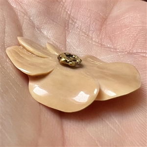 Carved fossilized natural material button of realistic flower with real gold center. 