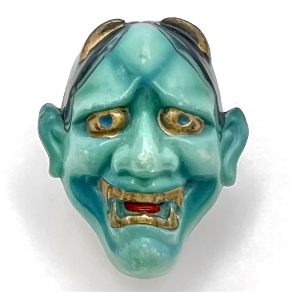 Realistic porcelain Arita Noh theater mask button.