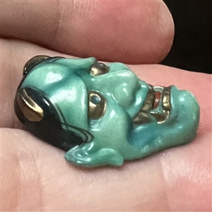 Realistic porcelain Arita Noh theater mask button.