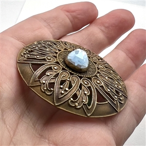 Extra large brass button with oval faceted  glass imitation gem.
