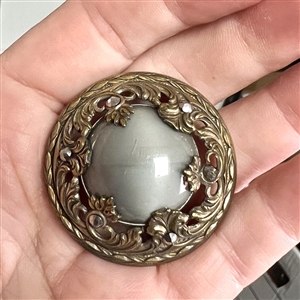Gay 90's grey glass set in metal button.