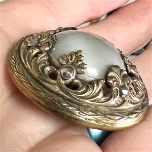 Gay 90's grey glass set in metal button.