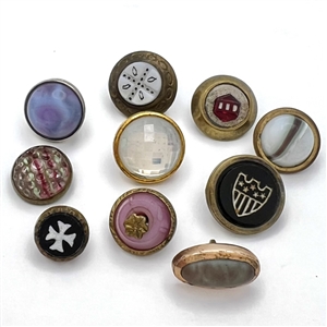 Ten glass in metal weskit buttons including a Cheshire and a Saphiret.