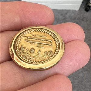 Brass button of an early airplane.