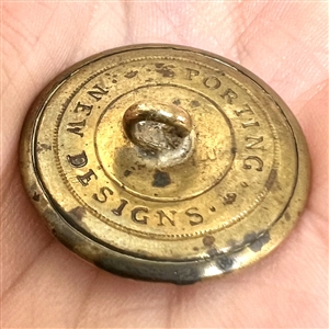 Gilded brass sporting button of a sporting awards cup.