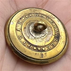 Gilded brass sporting button of wolf caught in a trap.