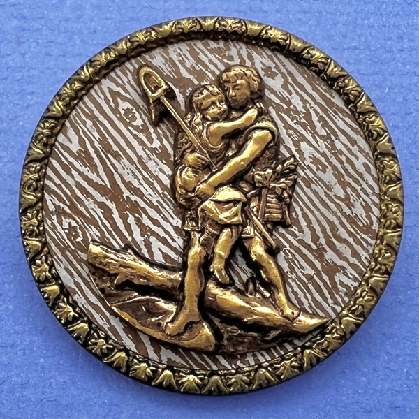 Brass button of St. Christopher carrying a child. 