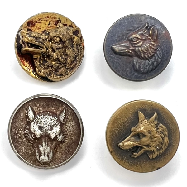 Four sporting buttons of wolves and foxes.