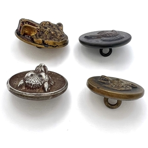 Four sporting buttons of wolves and foxes.