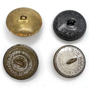 Four sporting buttons of wolves and foxes.