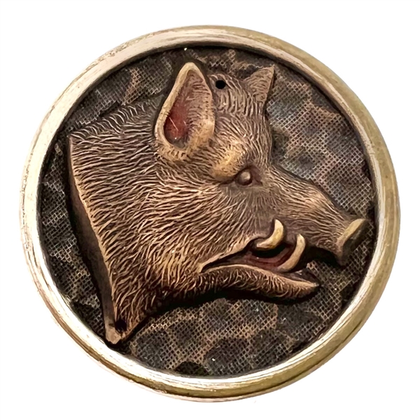 Stamped and tinted button of a boars head.