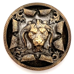 Brass button of a lions head bursting through.