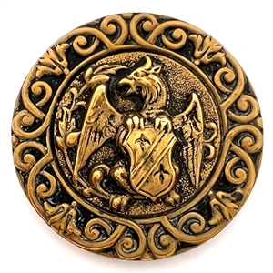 Brass button of a creature holding a shield. 
