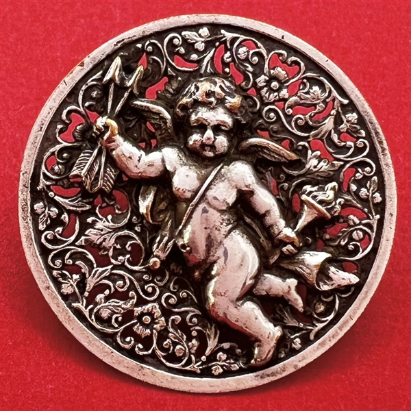 Silvered brass button of cupid.