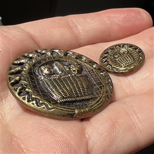 Two brass button of “kittens in a basket in mother daughter sizes.