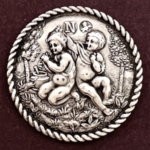 Hallmarked silver button of putti processing grapes for wine. 