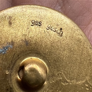 German glass chestnut set in metal button.