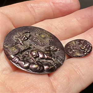 Two purple tinted brass buttons of “Phaethon in mother daughter sizes. 