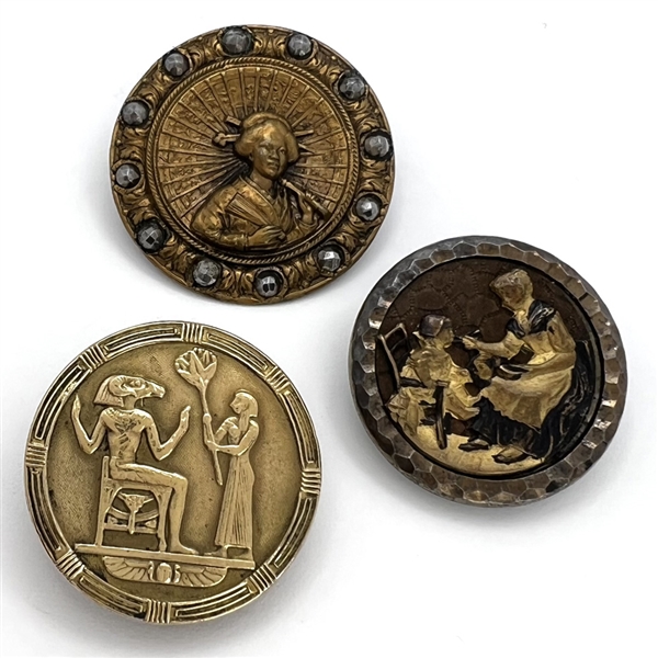 Three brass story buttons.