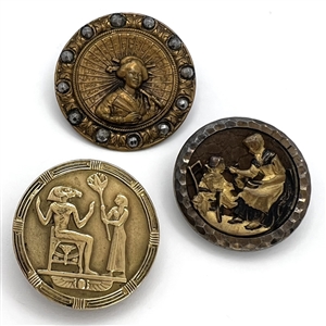 Three brass story buttons.