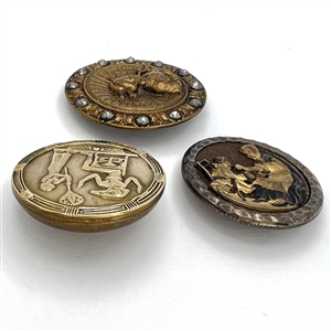 Three brass story buttons.