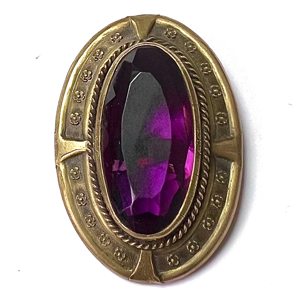 Gay 90s faceted amethyst glass set in metal button.