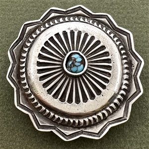 Native American silver button with turquoise center.