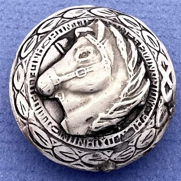 Modern Native American silver button of a horse head.