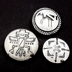 Three modern Native American silver buttons with assorted images.