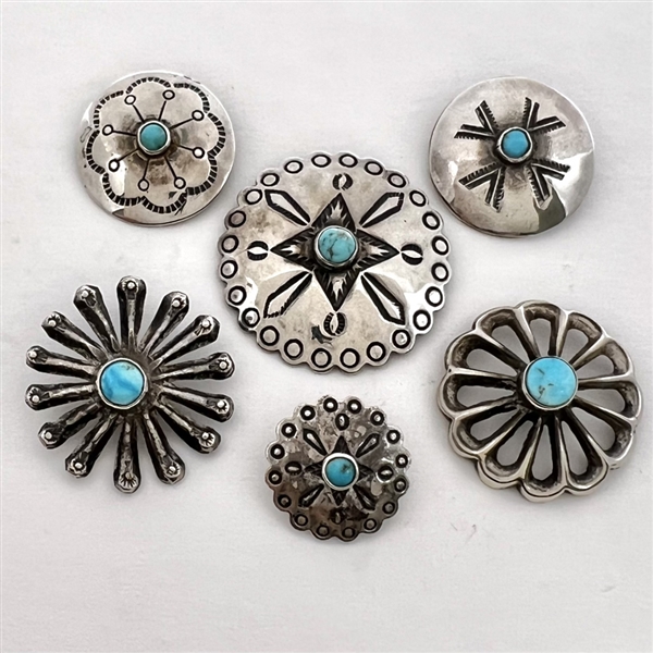 Six Native American silver buttons with turquoise centers.