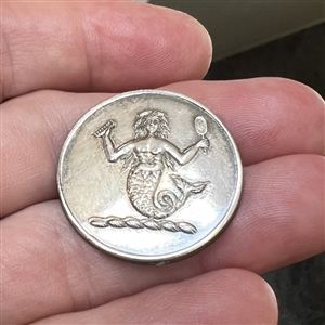 Livery crest button of a mermaid.