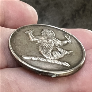 Livery crest button of a mermaid.